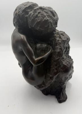statue of a woman hugging a rock on a white background