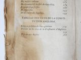 an old book with writing on it sitting on a table