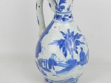 a blue and white vase with a bird on it