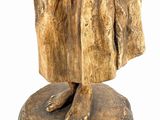 statue of a woman in a fur coat with a hat on her head