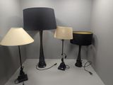 three lamps that are sitting on a white table