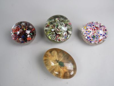 four different types of marbles are displayed on a white surface