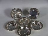 six silverplated dishes on a white surface