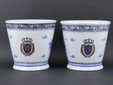pair of blue and white porcelain cups with crest and crest on them