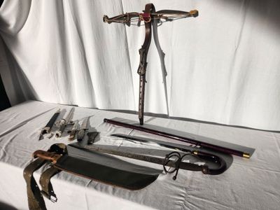a table with a cross, knife, and other items on it