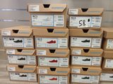 boxes of shoes are stacked on top of each other in a store