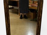 a woman standing in front of a mirror in a room