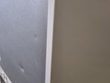 a white refrigerator that is sitting on a cart in a room