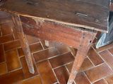 a small wooden table with a green tag on it