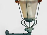 a green street light with a white candle on it