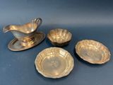 four pieces of silverware including a saucer, bowl and saucer