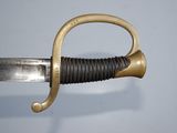 a close up of a sword with a gold handle on a blue background