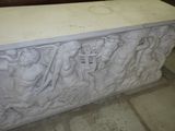 a white marble sculpture with a group of people on it