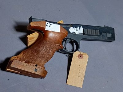 a wooden gun with a tag on it and a tag attached to it