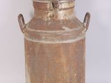 a large metal container with handles on a white surface
