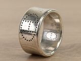 an image of a silver ring with dots on it