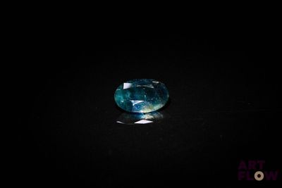 un gros plan d'un saphir bleu sur une surface noire