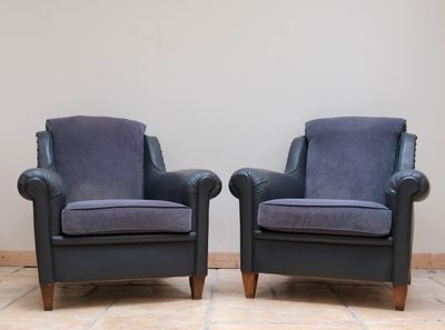 pair of mid - century style armchairs in blue velvet upholstered with walnut legs