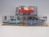 three toy cars are in a clear box on a white surface