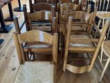 de nombreuses chaises en bois alignées en rang dans une pièce