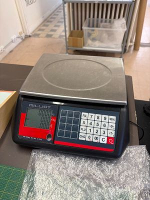 une balance sur laquelle est posée une calculatrice