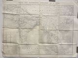 an old map of the world is hanging on a wall