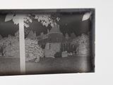 a black and white photo of a house with trees in front of it