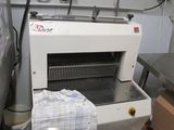 a machine that is sitting in a kitchen next to a table