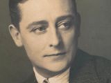 a black and white photo of a man in a suit and tie