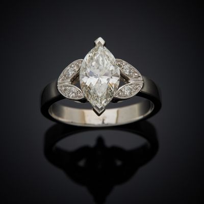 a close up of a diamond ring on a black surface
