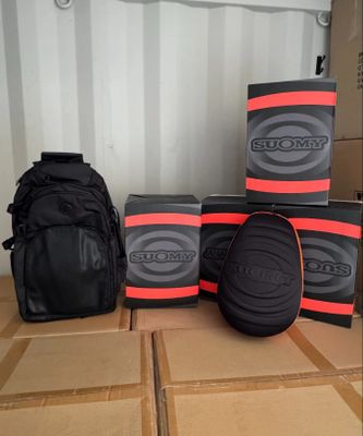 several boxes of skateboard gear sitting on top of a cardboard box