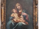 une peinture ancienne représentant une femme tenant un enfant dans ses bras