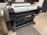 a large printer sitting on top of a cart in a room