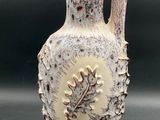 a white vase that is sitting on a table