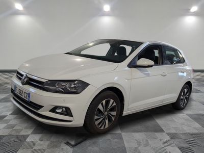 the white volkswagen polo is parked in a room with a checkered floor