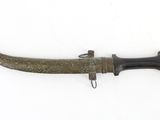 a close up of a knife on a white surface