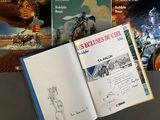 a lot of books that are on the table