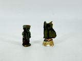two figurines that are standing next to each other