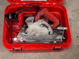 a red tool box with a red power drill inside of it
