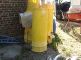 a yellow fire hydrant sitting next to a brick building