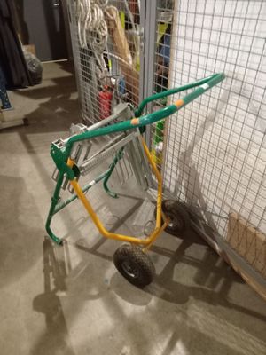 a green and yellow hand truck parked in front of a cage