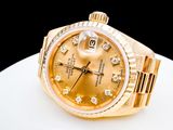 a gold rolex watch with diamonds on the bracelet