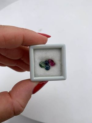 someone is holding a small white box with a ring inside of it