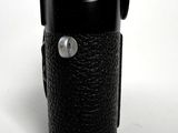 a black camera case that has a button on it