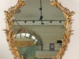 an image of a mirror with a gold frame and a gold leaf design