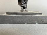 a statue of a woman holding a bird on a pedestal