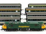 three green and yellow train cars sitting next to each other on a white surface