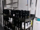 many cups and mugs sitting on the shelves in the kitchen