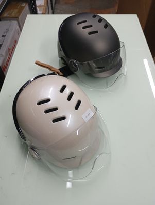 two helmets that are sitting on top of a table