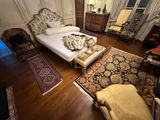a bedroom with a bed and a chair in it